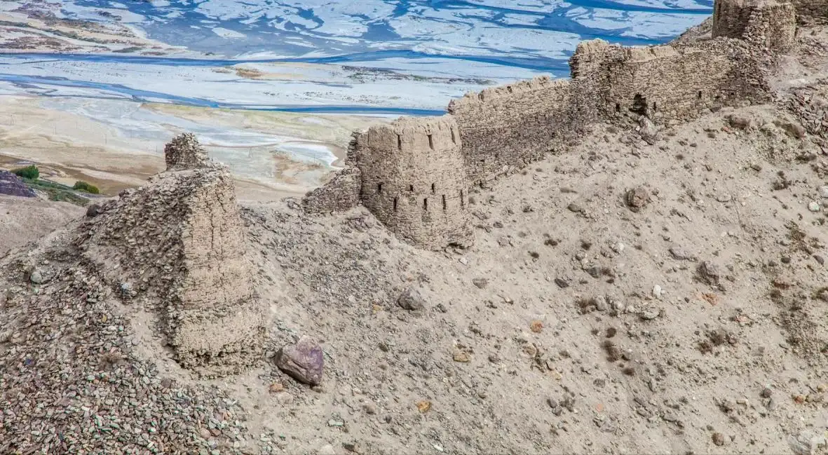 The walls and towers of Yamchun fortress on a sandy ridge above the Wakhan valley