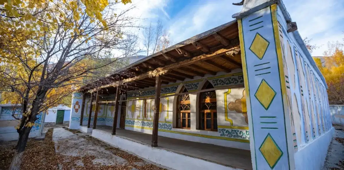 The painted wooden veranda of the Muborak Wakhoni house-museum in Yamd